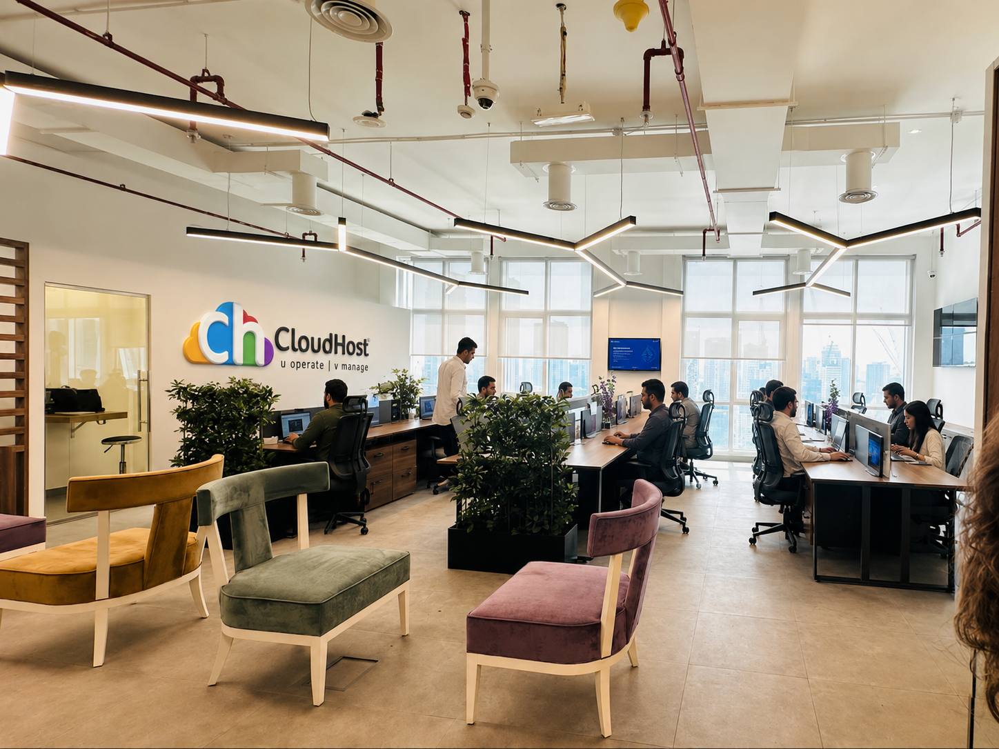 CloudHost team collaborating in a bright, plant-filled office